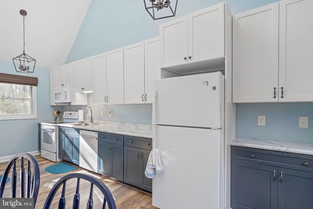 kitchen featuring white cabinetry, sink, hanging light fixtures, light hardwood / wood-style floors, and white appliances