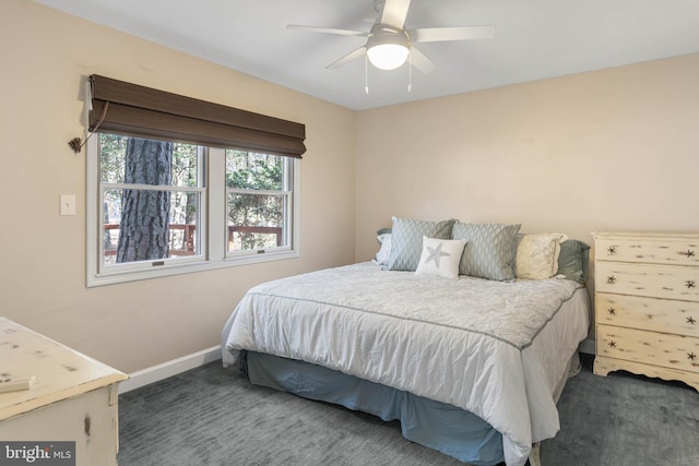 bedroom featuring ceiling fan and dark carpet