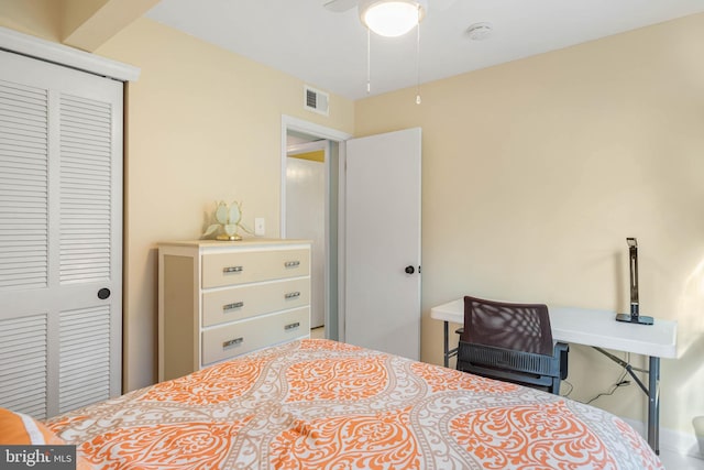 bedroom with ceiling fan and a closet