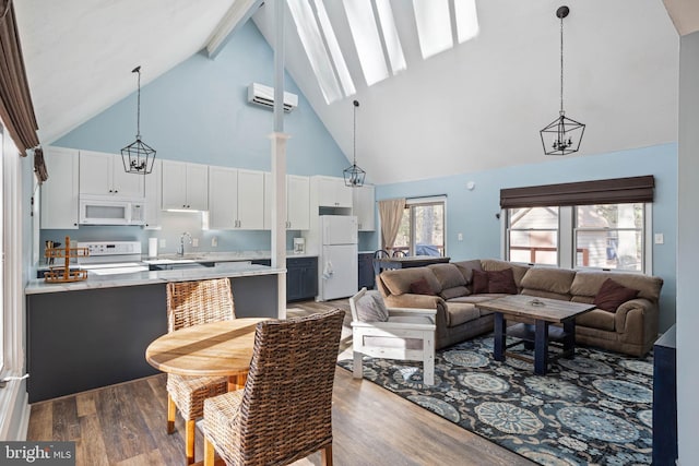 living room featuring a wall mounted air conditioner, sink, wood-type flooring, high vaulted ceiling, and a notable chandelier