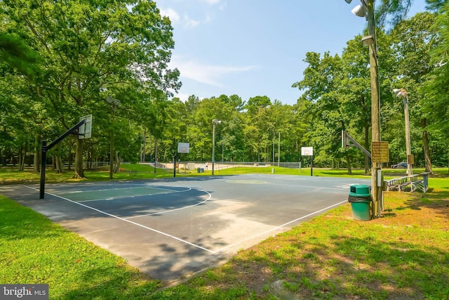 view of sport court with a lawn