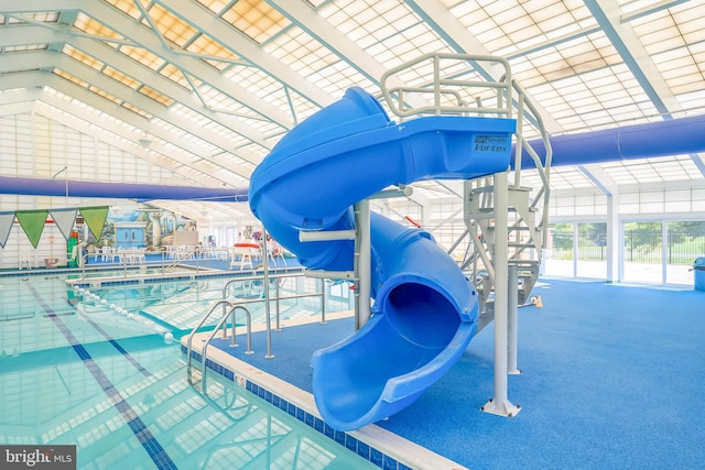 view of pool featuring a playground and a water slide