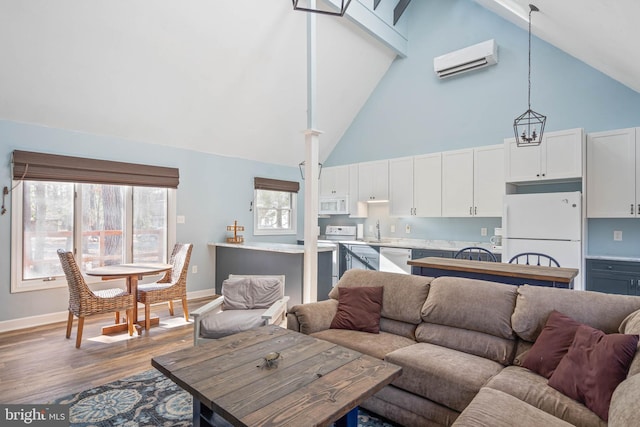 living room with sink, an AC wall unit, dark wood-type flooring, and high vaulted ceiling