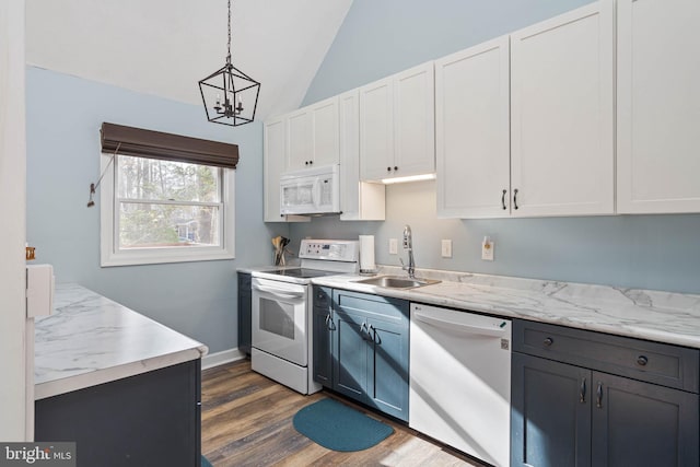 kitchen with pendant lighting, lofted ceiling, white appliances, sink, and white cabinetry