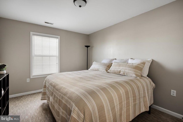 bedroom with dark colored carpet