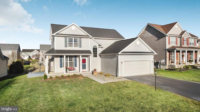 front of property featuring covered porch, a front yard, and a garage