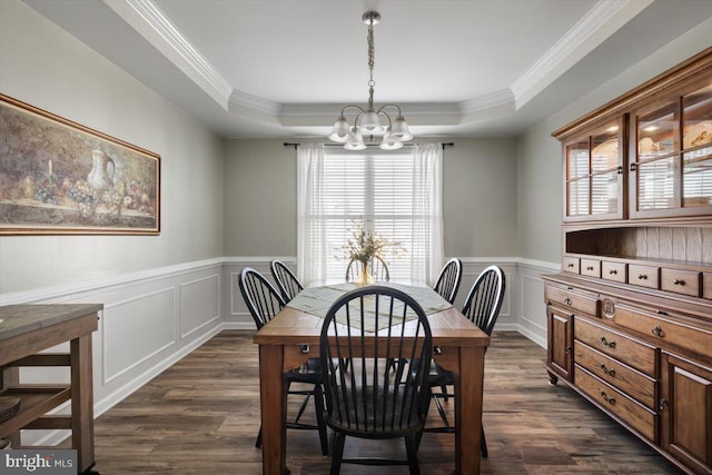 dining room with ornamental molding, a raised ceiling, plenty of natural light, and dark wood-type flooring