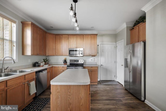 kitchen featuring sink, dark wood-type flooring, decorative light fixtures, a kitchen island, and appliances with stainless steel finishes