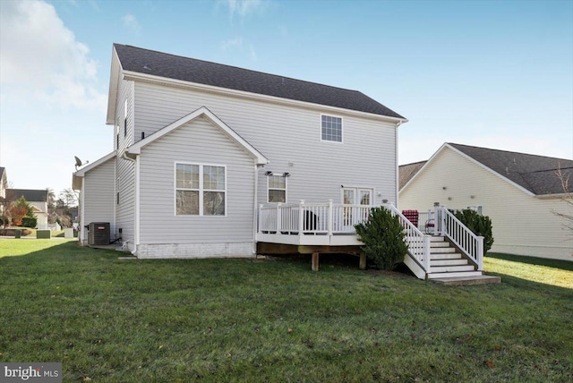 rear view of property with a wooden deck, a yard, and central AC unit