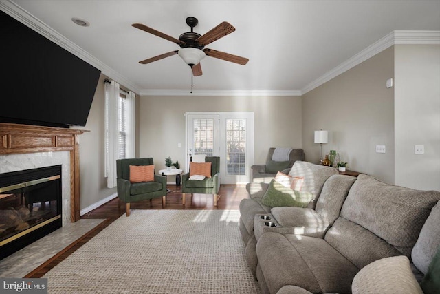 living room with hardwood / wood-style floors, ceiling fan, and ornamental molding