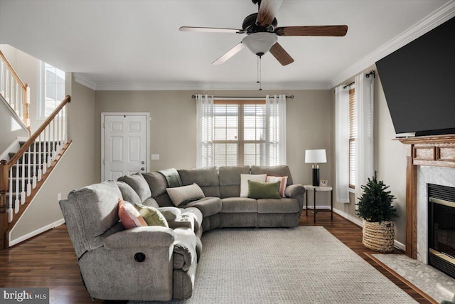 living room with ceiling fan, a fireplace, dark wood-type flooring, and ornamental molding