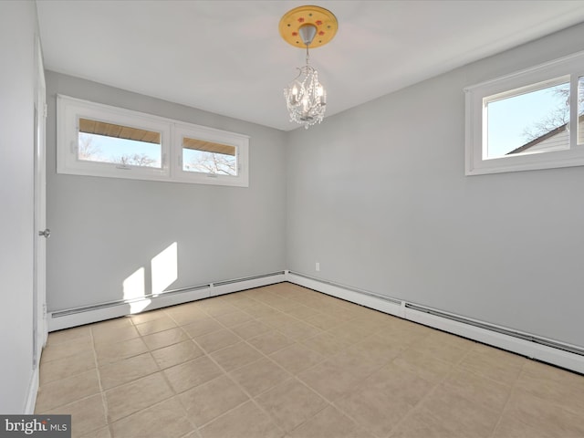 tiled empty room with an inviting chandelier and plenty of natural light