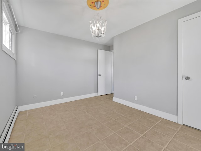 tiled empty room with baseboard heating and a notable chandelier