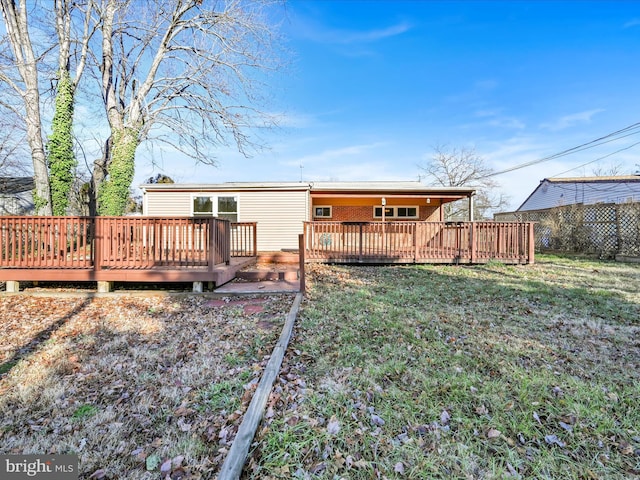 back of property with a deck and a lawn