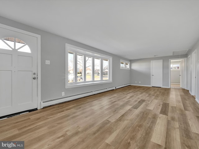 entryway with baseboard heating, a wealth of natural light, and light hardwood / wood-style flooring