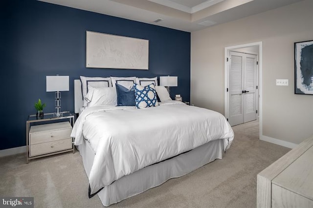 bedroom with light colored carpet and a closet