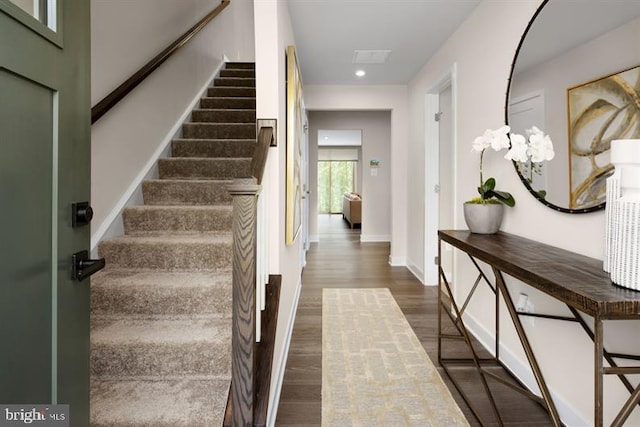 stairs with hardwood / wood-style floors