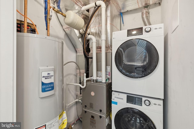 clothes washing area featuring water heater and stacked washer and dryer