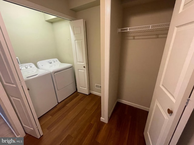 laundry room featuring washer and dryer and dark hardwood / wood-style floors