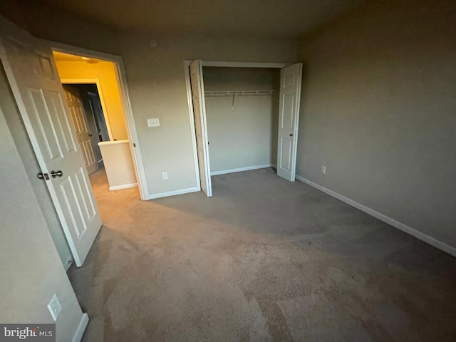 unfurnished bedroom featuring carpet and a closet