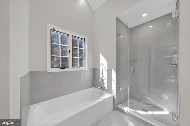 bathroom featuring vaulted ceiling and shower with separate bathtub