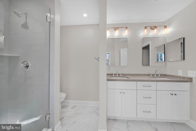 bathroom with vanity, an enclosed shower, and toilet