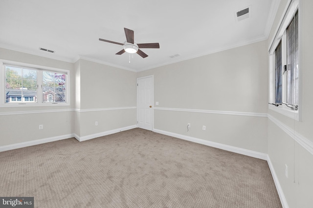 carpeted empty room featuring ceiling fan and crown molding