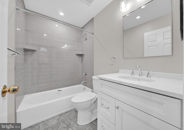 full bathroom featuring vanity, tiled shower / bath combo, and toilet