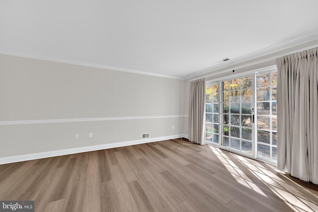 spare room with light hardwood / wood-style floors and ornamental molding