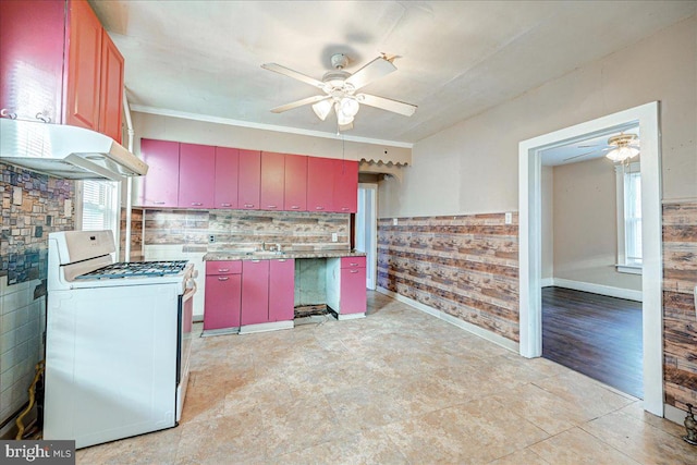 kitchen with white range with gas cooktop, crown molding, and ceiling fan