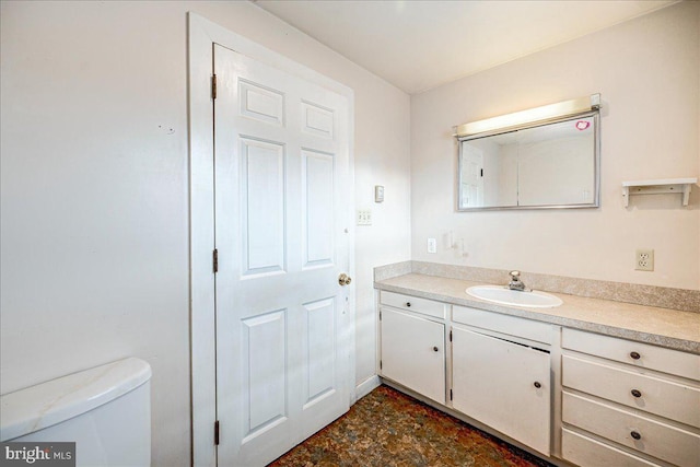 bathroom featuring vanity and toilet