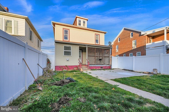 rear view of house with a yard