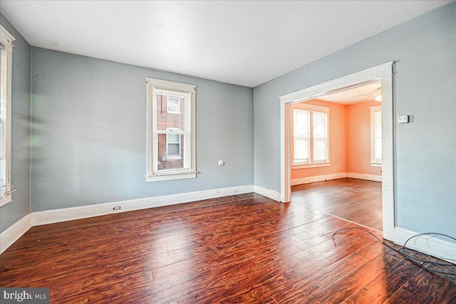 unfurnished room featuring dark wood-type flooring