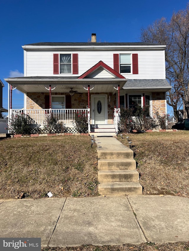 view of front of property with a porch and a front lawn