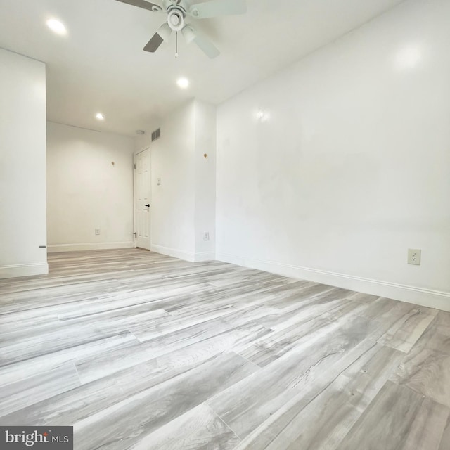 empty room with light wood-type flooring and ceiling fan