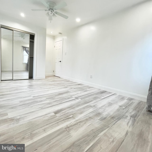 spare room featuring ceiling fan and light hardwood / wood-style floors