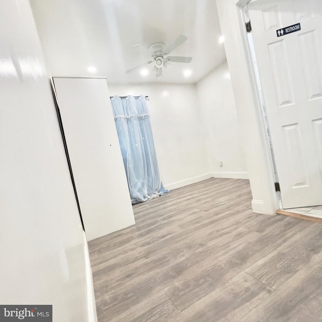 unfurnished bedroom featuring ceiling fan and light hardwood / wood-style flooring