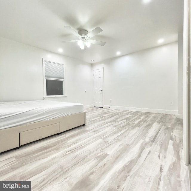 unfurnished bedroom with ceiling fan and light wood-type flooring