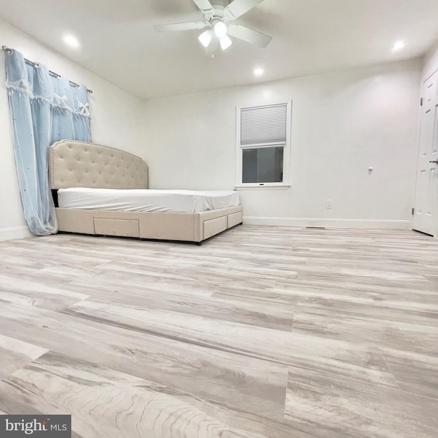 bedroom with ceiling fan and light wood-type flooring