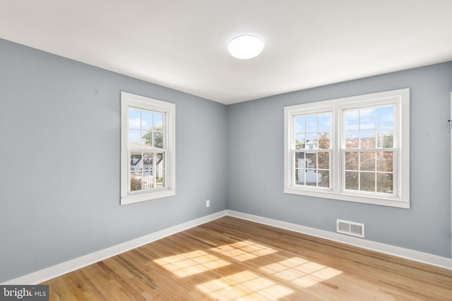 unfurnished room with wood-type flooring