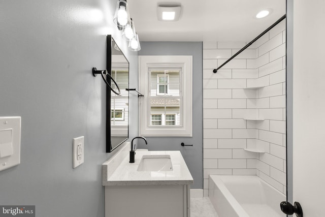 bathroom featuring vanity and tiled shower / bath combo