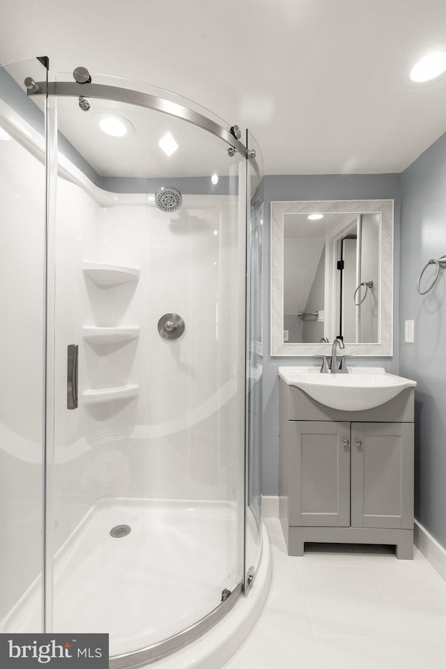 bathroom with tile patterned floors, vanity, and walk in shower