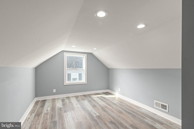 bonus room featuring light hardwood / wood-style floors and lofted ceiling