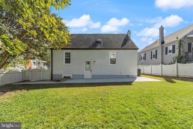 rear view of house featuring a lawn, cooling unit, and a patio