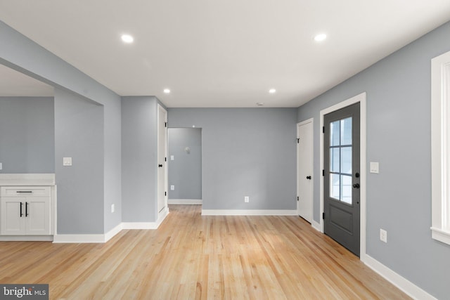 foyer entrance with light hardwood / wood-style floors