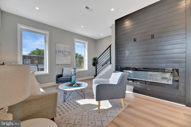 living area featuring a fireplace and light hardwood / wood-style flooring