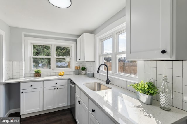 kitchen with backsplash, white cabinetry, sink, and a wealth of natural light