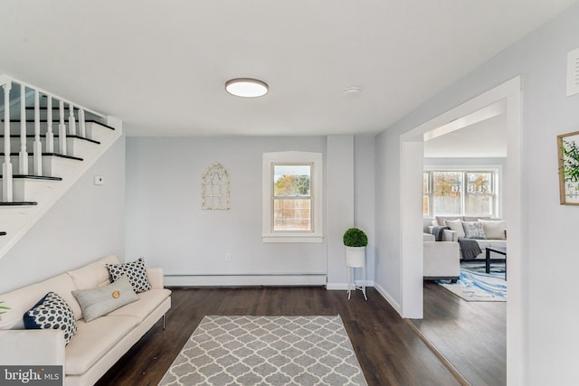 living room featuring dark wood-type flooring, plenty of natural light, and a baseboard radiator