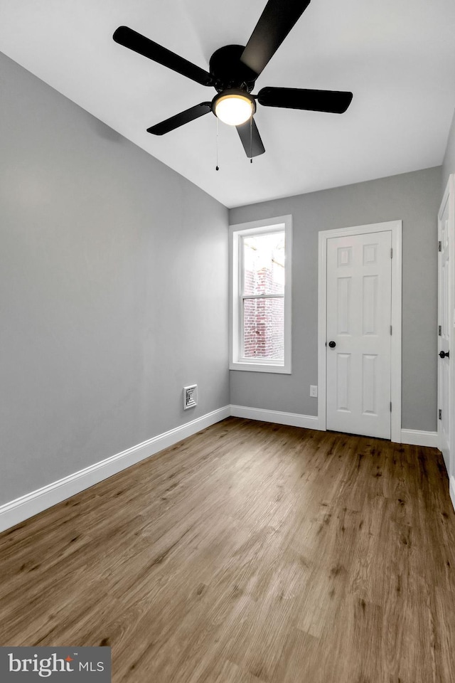 spare room featuring light hardwood / wood-style floors and ceiling fan