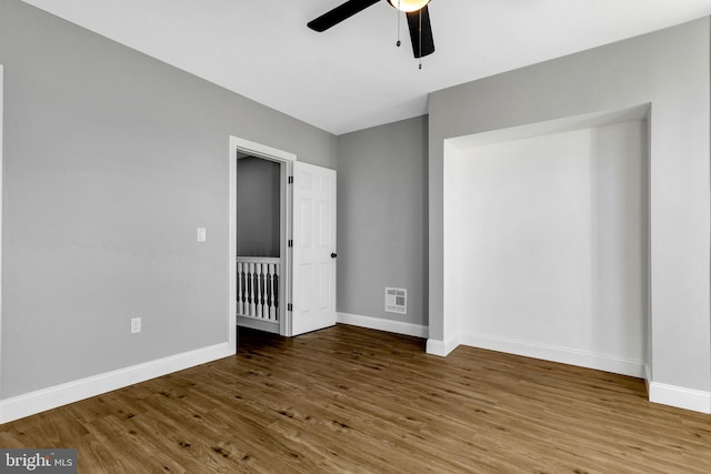 unfurnished bedroom with ceiling fan and wood-type flooring